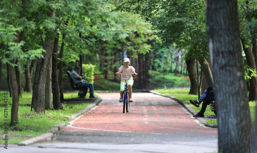 teenage girl riding her bike in the park teenage girl riding her bike in the park