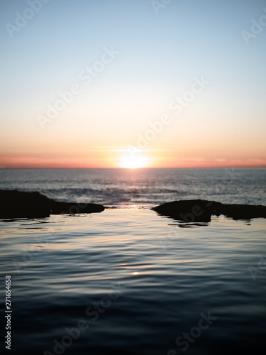 Calm water during sunset on wild beach in Basque Country