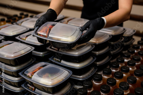 Lunch box with food in the hands. Catering