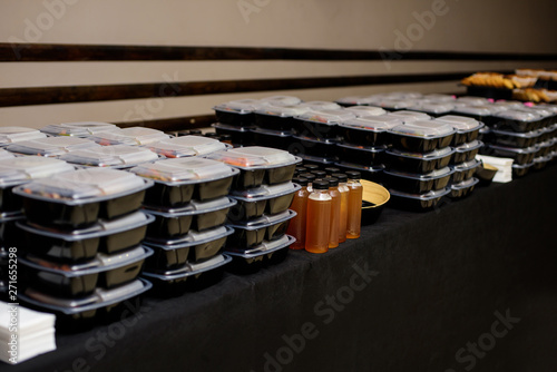 Fotografie Black lunch box with food. Catering