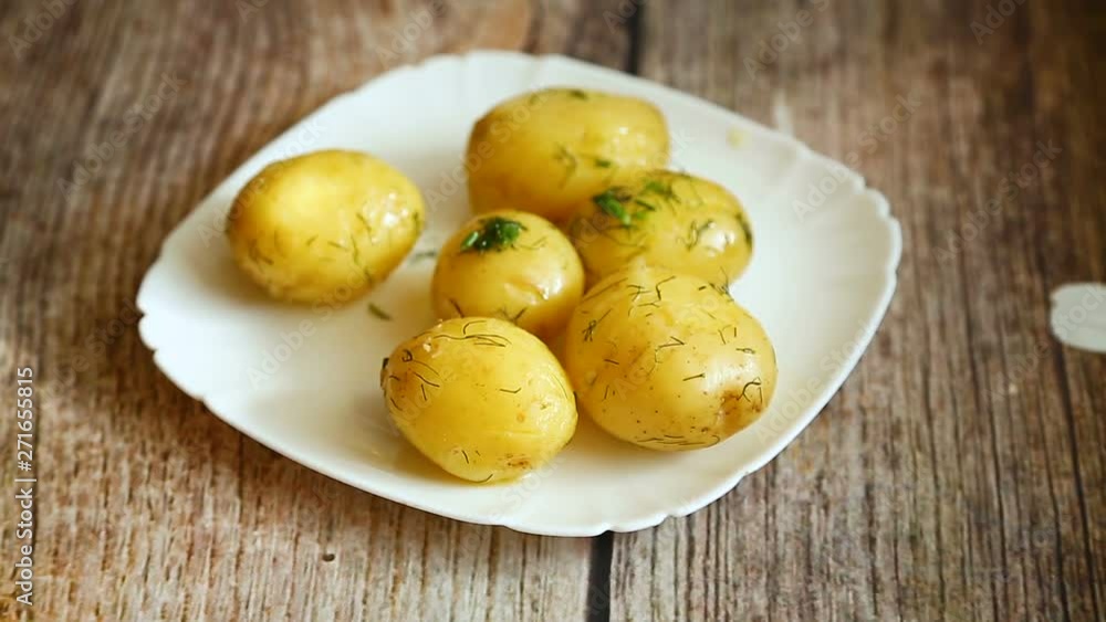 boiled young potato with butter and dill in a plate boiled young potato with butter and dill in a plate