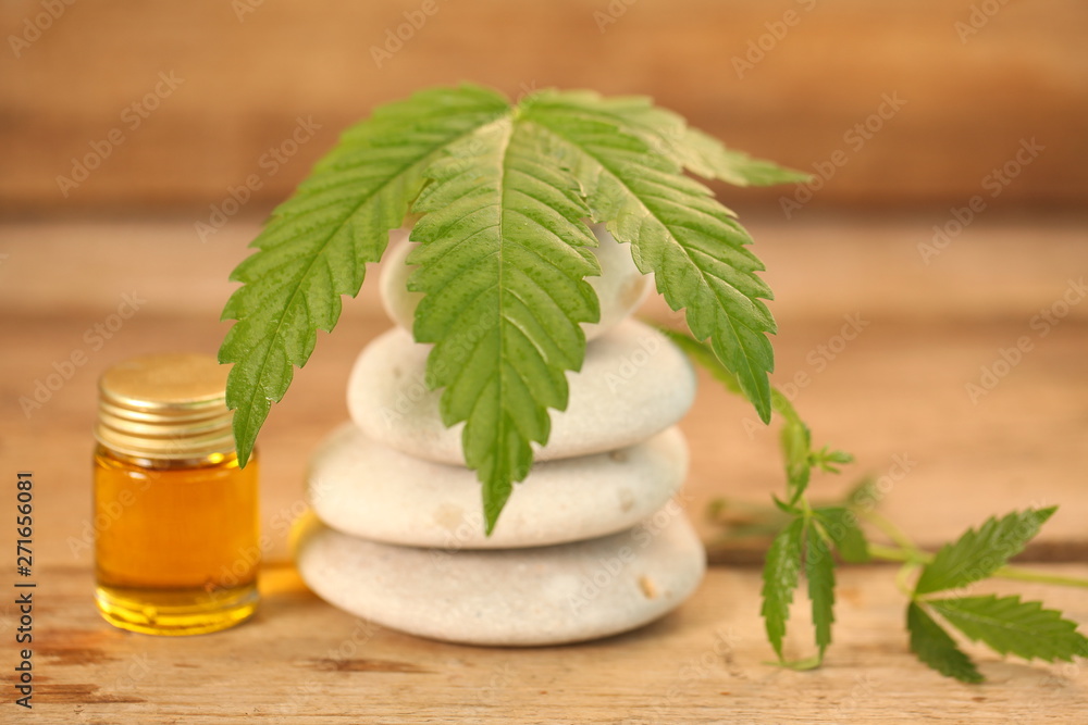 cbd oil bottle and hemp leaf . medical cannabis cbd oil bottle and hemp leaf . medical cannabis