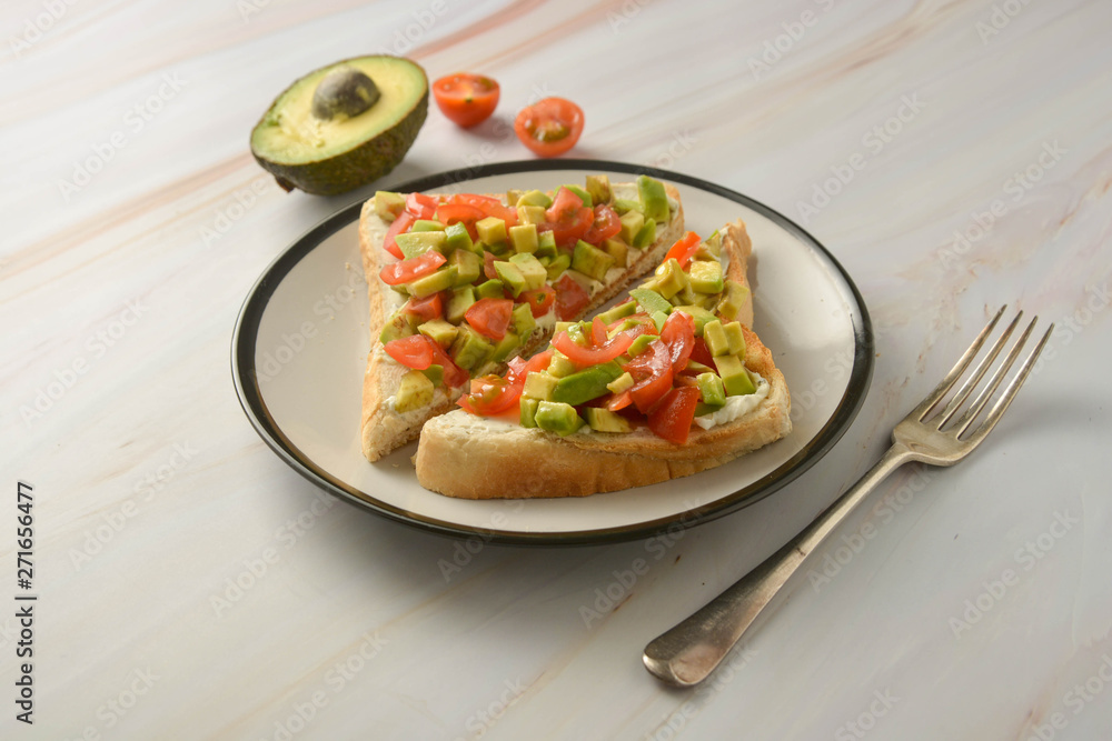 Toast with cream cheese, avocado and cherry tomatoes. Healthy food. Toast with cream cheese, avocado and cherry tomatoes. Healthy food.