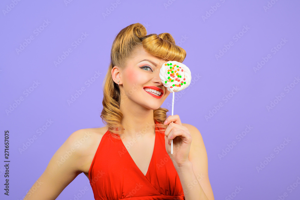 Lollipop. Sweet food. Sweets. Dessert. Smiling woman covering eye by lollipop. Pin up woman with lollipop in hand. Sexy girl with colourful candy. Candy store. Candy shop. Candy bar. Lollipop. Sweet food. Sweets. Dessert. Smiling woman covering eye by lollipop. Pin up woman with lollipop in hand. Sexy girl with colourful candy. Candy store. Candy shop. Candy bar.