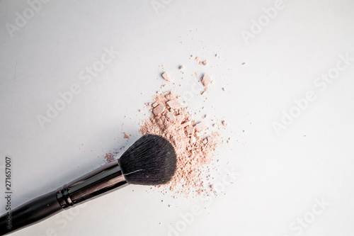 cosmetic powder slide and black makeup brush