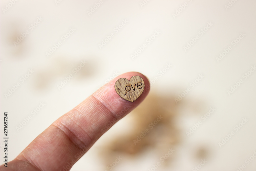 Heart with the inscription love in hand. Wooden heart in hand. Heart in hand. Heart with the inscription love in hand Heart with the inscription love in hand. Wooden heart in hand. Heart in hand. Heart with the inscription love in hand