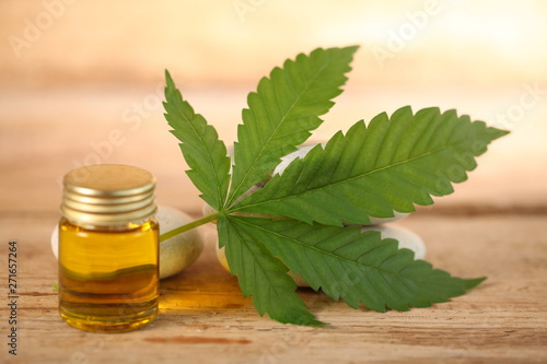 cbd oil bottle and hemp leaf . medical cannabis
