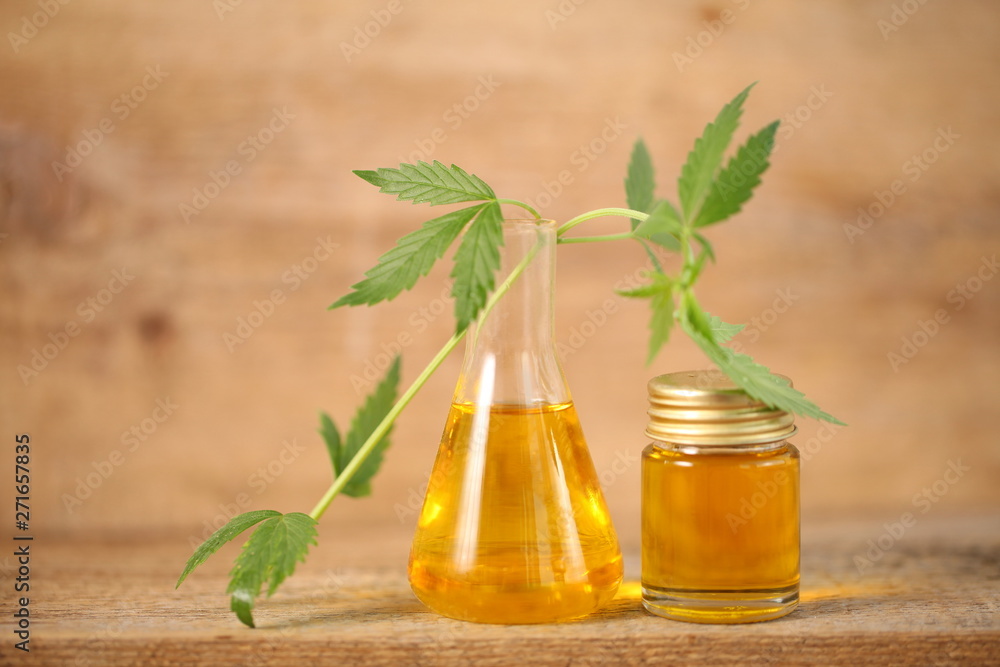 cbd oil bottle and hemp leaf . medical cannabis cbd oil bottle and hemp leaf . medical cannabis