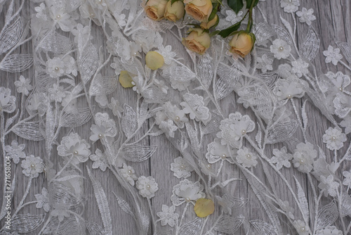 The texture of lace on wooden background decoreted roses. photo