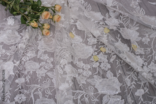 The texture of lace on wooden background decoreted roses. photo