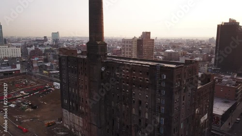 Panning aerial, old building in New York City at sunset