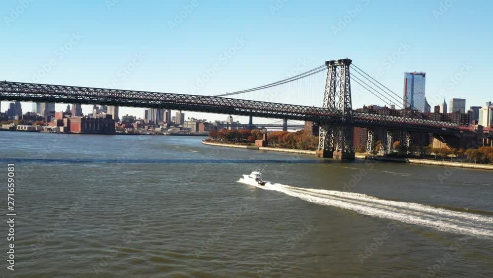 Boat speeds under Williamsburg Bridge, aerial Boat speeds under Williamsburg Bridge, aerial