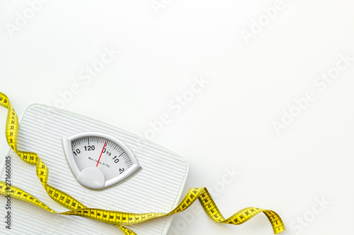 Slim concept with scale and measuring tape on white background top view mockup photo