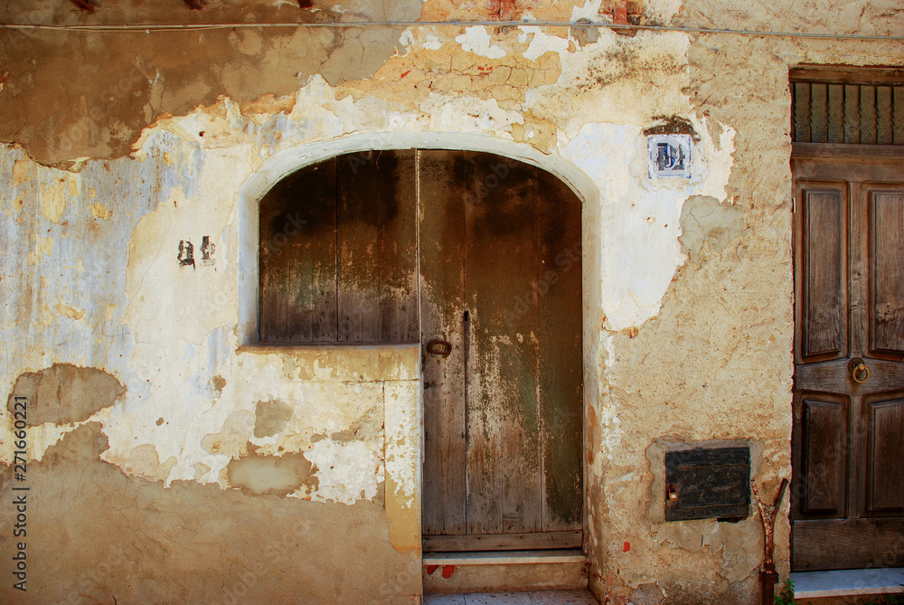 old window on the wall of an ancient house in the medieval village of Pollina in Sicily