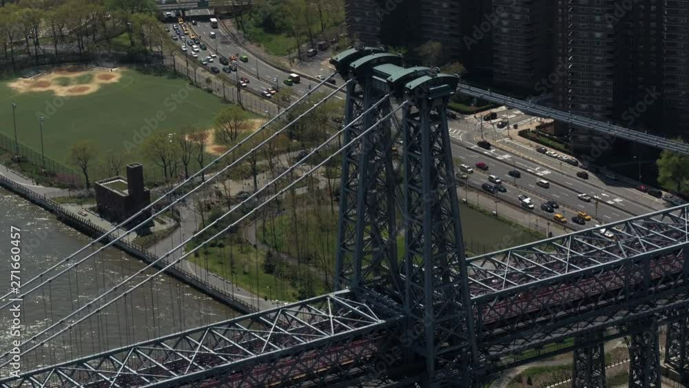 Tilt down, cars drive past Williamsburg Bridge Tilt down, cars drive past Williamsburg Bridge