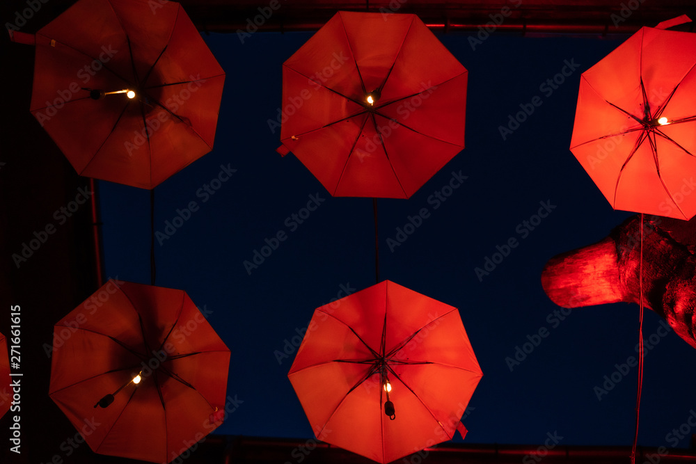 Flying red umbrellas pattern, part of inner courtyard decoration design, by night. Flying red umbrellas pattern, part of inner courtyard decoration design, by night.
