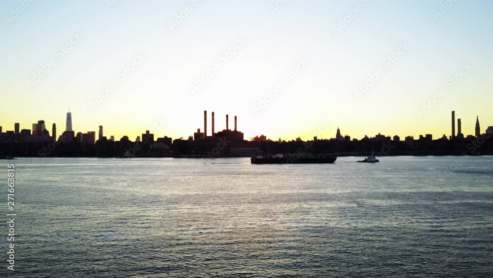 Large boat on East River at sunset, aerial Large boat on East River at sunset, aerial