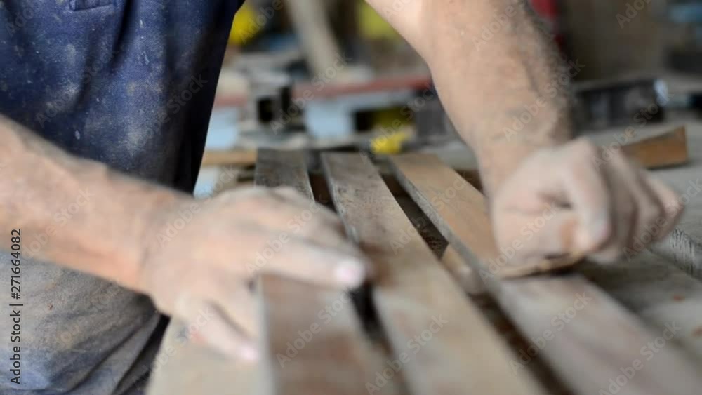 Professional carpenter sanding and restoring wooden surfaces. Professional carpenter sanding and restoring wooden surfaces.