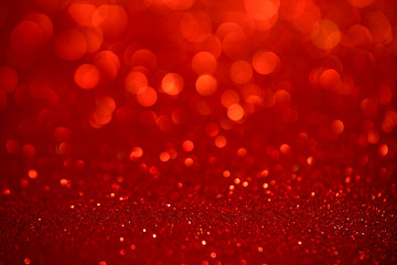 Red glitter christmas abstract background. Defocused sequin light.