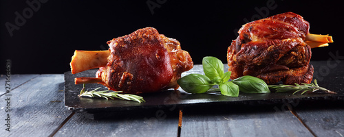 Canvas Print Smoked ham hock with herbs and spices on stone plate.