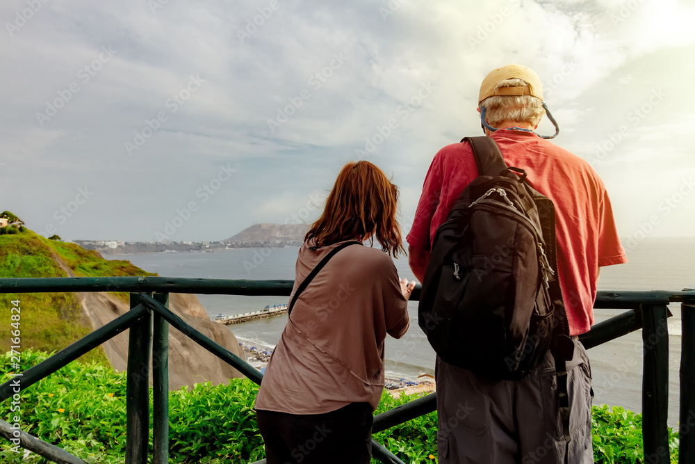 Couple of adults observe the sea from the Love Park of Miraflores district in Lima, Peru