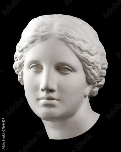Gypsum copy of ancient statue Venus head isolated on black background. Plaster sculpture woman face.