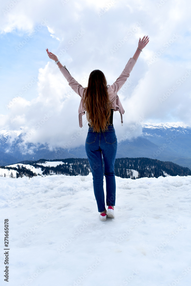 Beautiful girl in the snowy mountains with long wavy hair Beautiful girl in the snowy mountains with long wavy hair