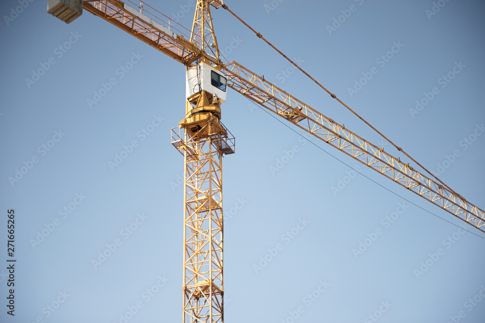 Crane. Construction crane. Huge crane against blue sky. Tower crane. Crane. Construction crane. Huge crane against blue sky. Tower crane.