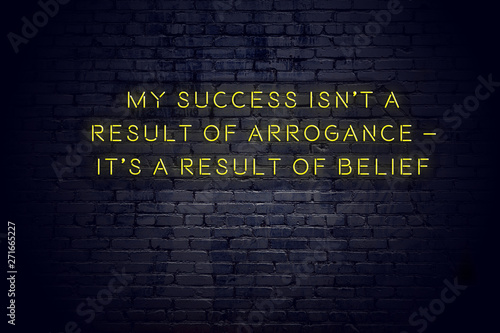 Valokuva Neon sign with positive wise motivational quote against brick wall