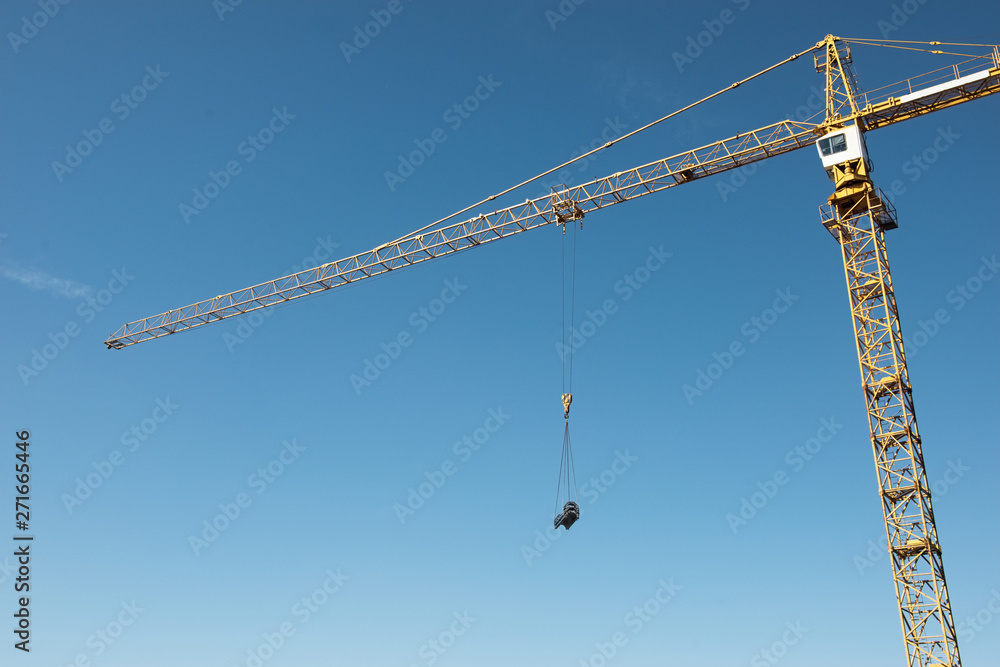 Crane. Construction crane. Huge crane against blue sky. Tower crane. Crane. Construction crane. Huge crane against blue sky. Tower crane.