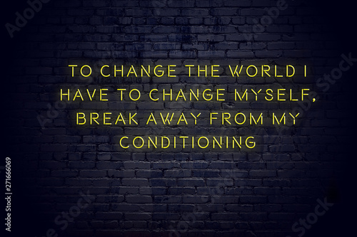 Photos Neon sign with positive wise motivational quote against brick wall