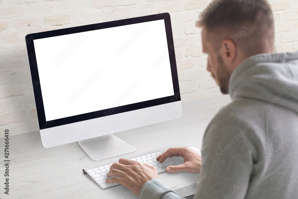 Man work on computer concept. Isolated, white, blank screen on computer display for mockup. Man work on computer concept. Isolated, white, blank screen on computer display for mockup.