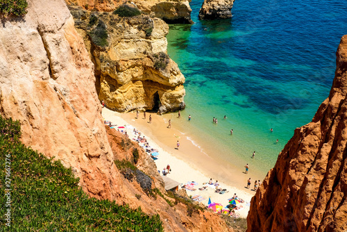 Praia Do Camilo on the Algarve coast in Portugal, people on the beach, view from above