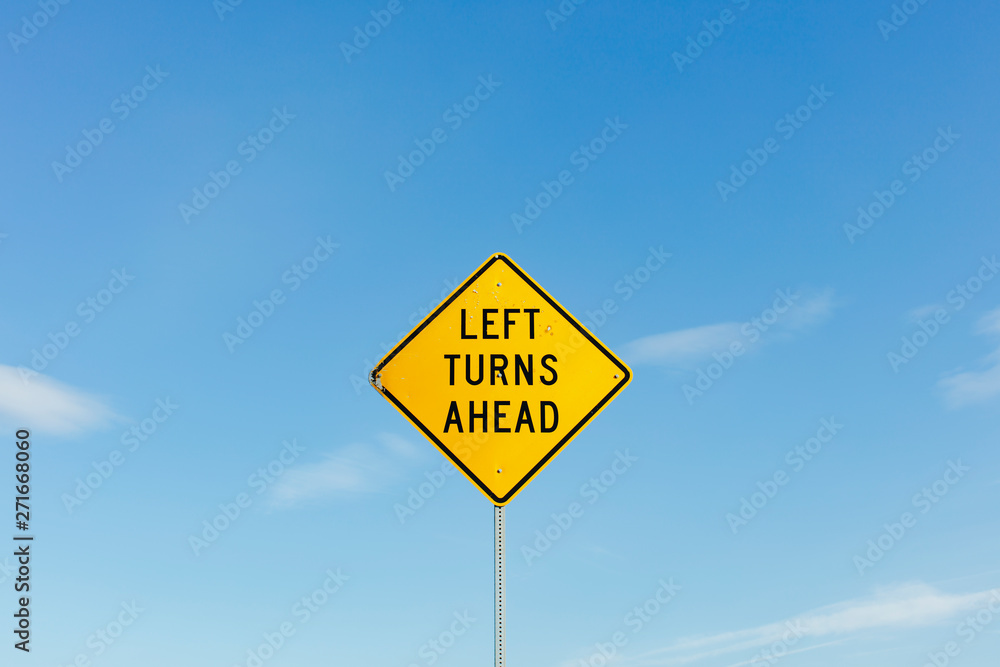 Left Turns Ahead yelloow traffic sign,Left Turns Ahead sign, blue sky in background Left Turns Ahead yelloow traffic sign,Left Turns Ahead sign, blue sky in background