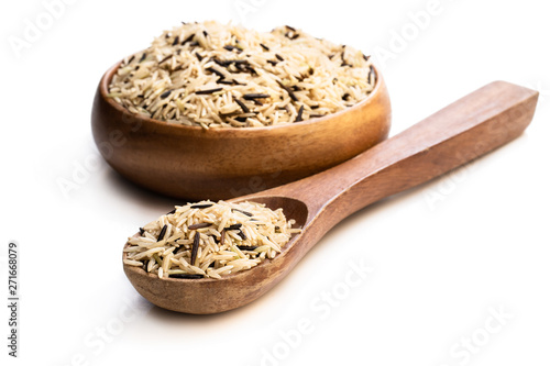 Wild brown basmati rice in a wooden bowl isolated on white