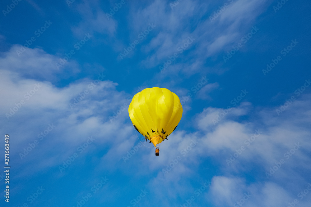 A Yellow Hot Air Balloon on a Blue Sky A Yellow Hot Air Balloon on a Blue Sky