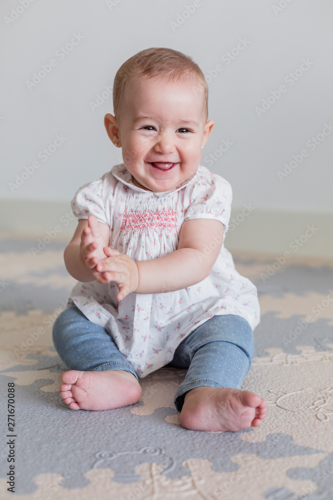 portrait of a beautiful baby girl at home. Family concept indoors. Daytime and lifestyle portrait of a beautiful baby girl at home. Family concept indoors. Daytime and lifestyle