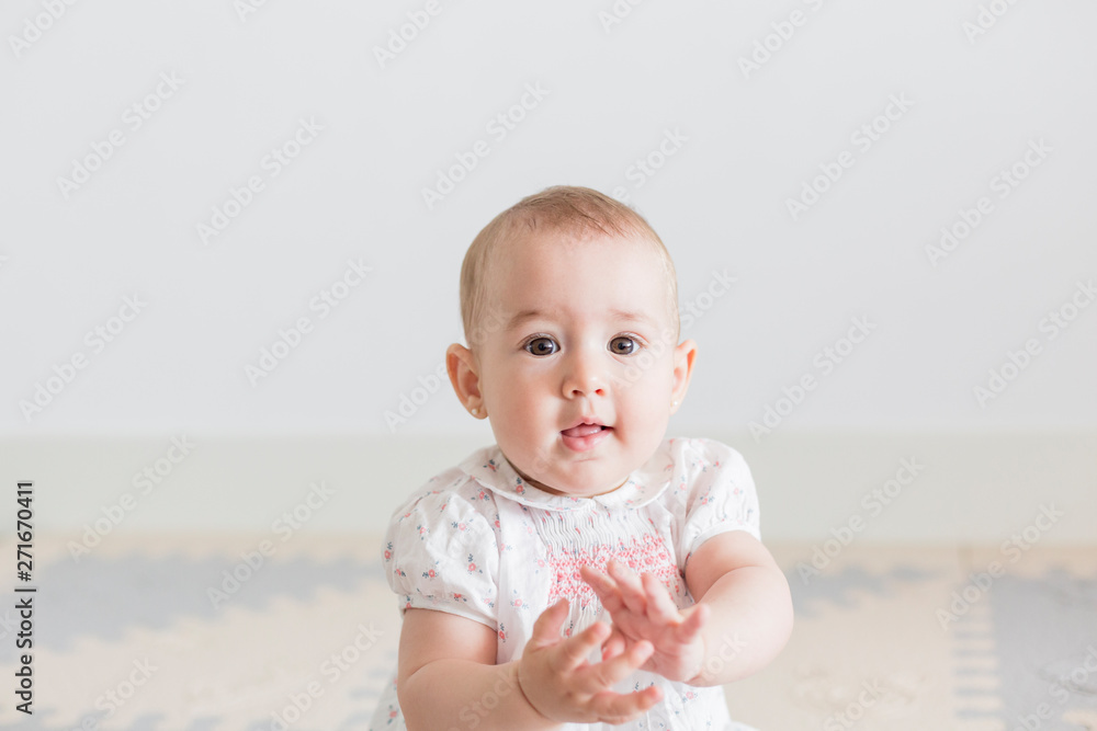 portrait of a beautiful baby girl at home. Family concept indoors. Daytime and lifestyle portrait of a beautiful baby girl at home. Family concept indoors. Daytime and lifestyle