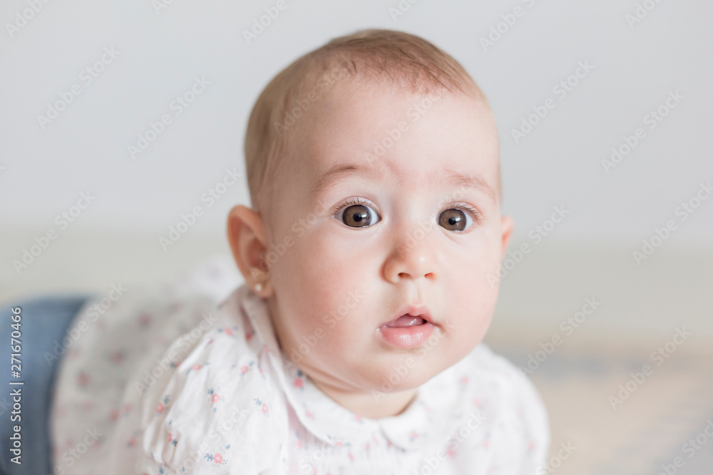 portrait of a beautiful baby girl at home. Family concept indoors. Daytime and lifestyle portrait of a beautiful baby girl at home. Family concept indoors. Daytime and lifestyle
