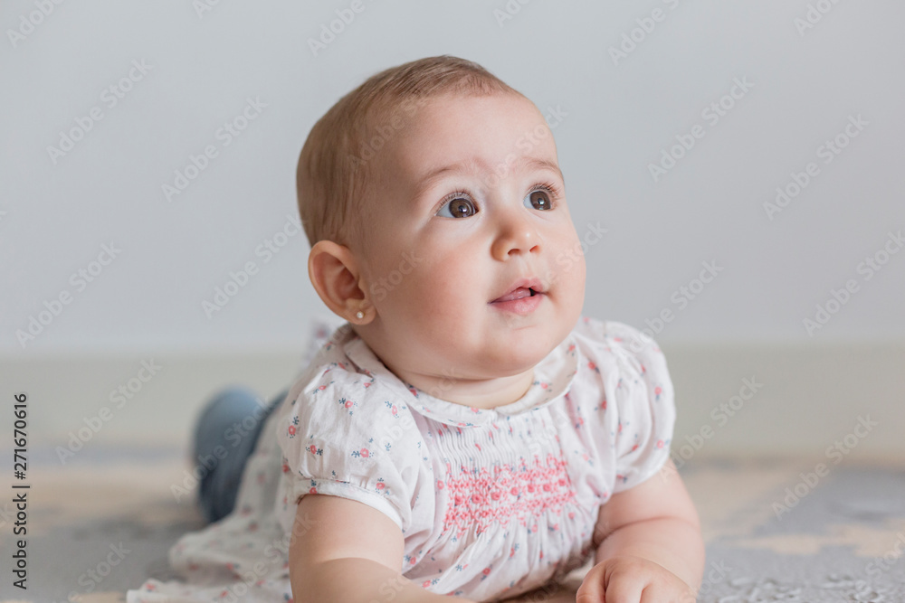 portrait of a beautiful baby girl at home. Family concept indoors. Daytime and lifestyle