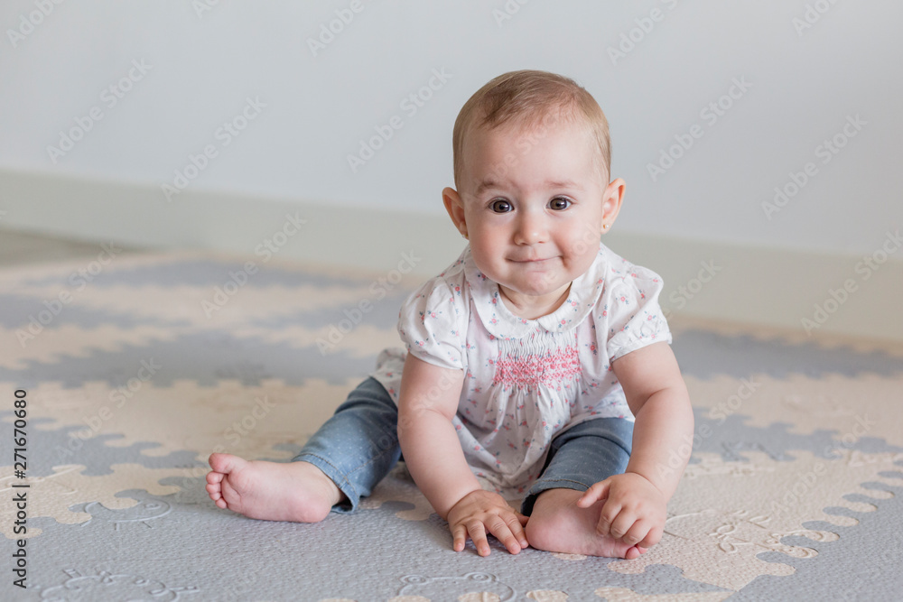 portrait of a beautiful baby girl at home. Family concept indoors. Daytime and lifestyle portrait of a beautiful baby girl at home. Family concept indoors. Daytime and lifestyle