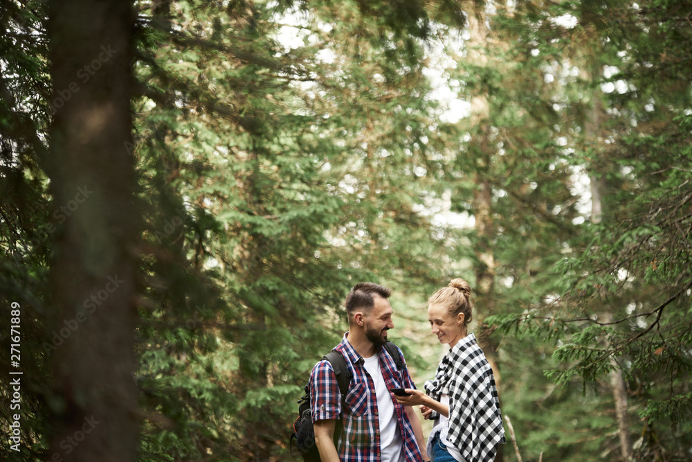 Couple with smart phone in the forest Couple with smart phone in the forest