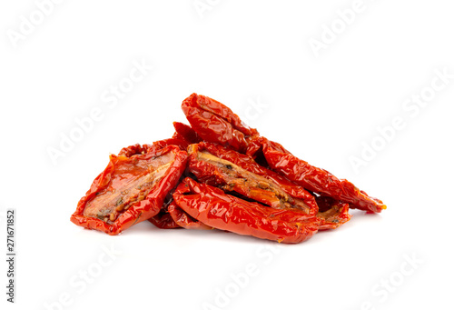 Dried tomatoes on a white background. Slices of dried tomatoes in oil close up.