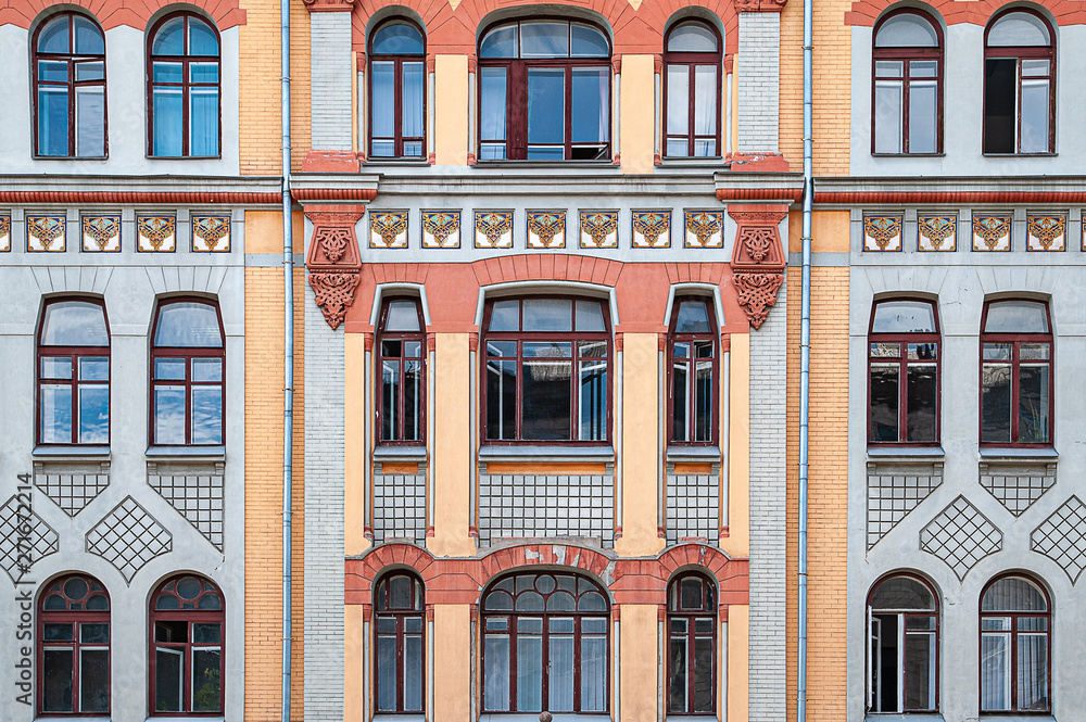 Many windows and a balcony on the facade of the old building.