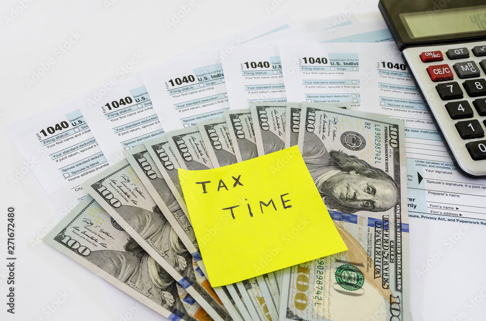 tax forms 1040, dollars and calculator on white background tax forms 1040, dollars and calculator on white background