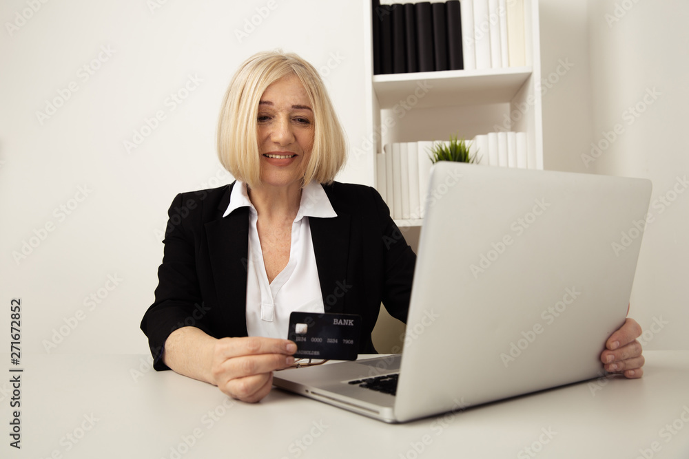 Office woman using black credit card on the computer Office woman using black credit card on the computer