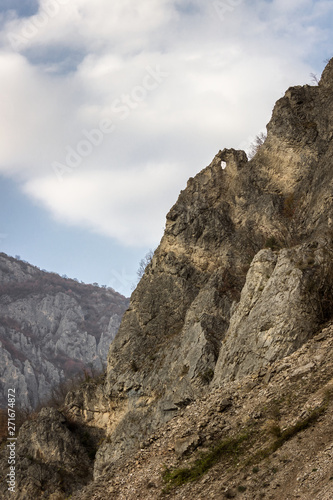 Pointy rock with a hole at the summit of a rocky mountain in the canyon of Jerma river in Serbia