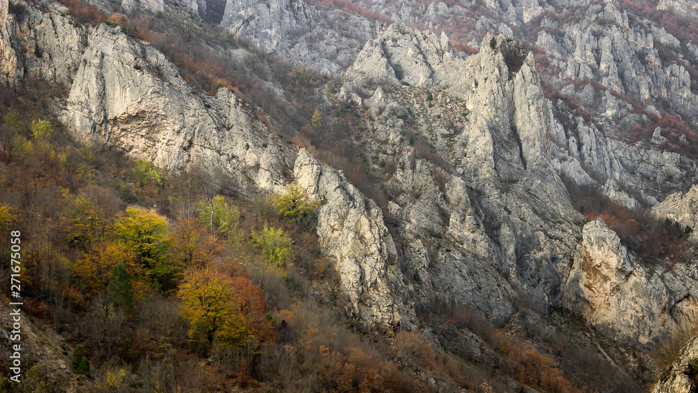 Rocky cliff, pointy rocks and autumn colored trees of canyon of Jerma river in Serbia
