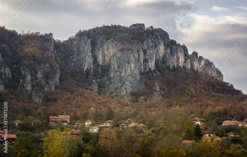 Scenic village Vlasi in against the rocky mountain at the entrance of Jerma river canyon in Serbia, near Pirot