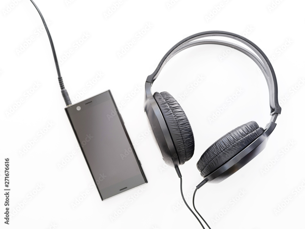 black headphones and black smartphone on white background black headphones and black smartphone on white background